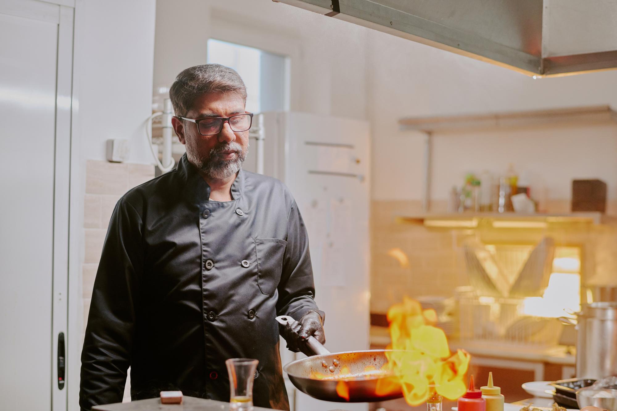 Portrait of founder chef in a small kitchen