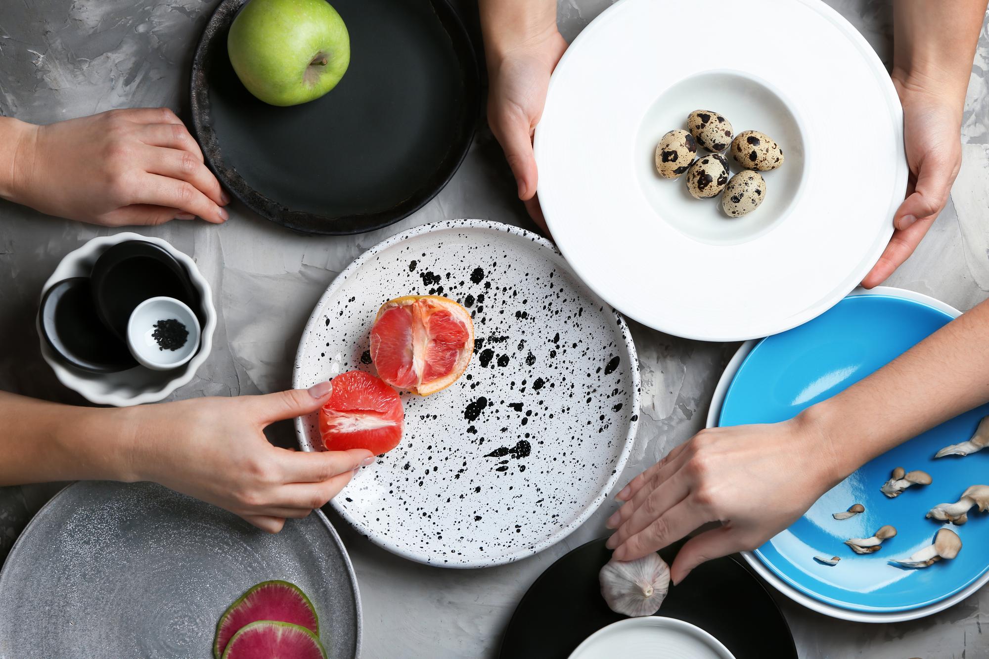 Small team arranging plated meals on a table